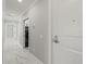 Hallway showcasing marble floors, neutral paint, and laundry space at 211 Dolphin Pt # 403, Clearwater Beach, FL 33767