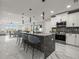 Beautiful kitchen with island, marble floors, stainless appliances, and modern lighting fixtures at 211 Dolphin Pt # 403, Clearwater Beach, FL 33767