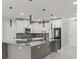 Well-equipped kitchen with a large center island, stainless steel appliances, and mosaic tile backsplash at 211 Dolphin Pt # 403, Clearwater Beach, FL 33767