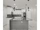 Modern kitchen with white cabinets, gray island and marble floors at 211 Dolphin Pt # 403, Clearwater Beach, FL 33767