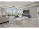 Bright living room featuring large windows, marble floors, and a stylish seating arrangement at 211 Dolphin Pt # 403, Clearwater Beach, FL 33767