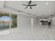 Open concept living room leading to a kitchen and balcony with waterfront views at 211 Dolphin Pt # 403, Clearwater Beach, FL 33767