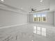 This bright living room has large windows and sleek, marble floors at 211 Dolphin Pt # 403, Clearwater Beach, FL 33767