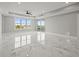 Spacious living room with tile floors, recessed lighting, and large windows at 211 Dolphin Pt # 403, Clearwater Beach, FL 33767