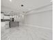 Spacious living space with kitchen, marble floors, and modern lighting fixtures at 211 Dolphin Pt # 403, Clearwater Beach, FL 33767