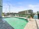 Waterfront view of the swimming pool with a dock and boat slips at 211 Dolphin Pt # 403, Clearwater Beach, FL 33767