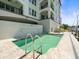 Building's pool deck featuring a pool, lounge chairs, and a view of the marina at 211 Dolphin Pt # 403, Clearwater Beach, FL 33767