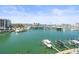 Scenic waterfront view featuring a marina with docked boats and city skyline in the distance at 211 Dolphin Pt # 403, Clearwater Beach, FL 33767