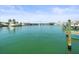 Picturesque waterfront view with boat docks, clear water, and beautiful buildings in the background at 211 Dolphin Pt # 403, Clearwater Beach, FL 33767