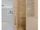Accessible walk-in shower featuring glass block and grab bars for added safety at 233 45Th Ave, St Pete Beach, FL 33706