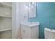 Updated bathroom with a modern vanity, mirror, and stylish blue tiled accent wall at 233 45Th Ave, St Pete Beach, FL 33706