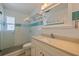 Bathroom with a shower, white vanity, granite countertop, a toilet, and decorative tile at 233 45Th Ave, St Pete Beach, FL 33706