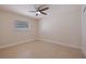 Bright bedroom featuring neutral walls, tile floors, a ceiling fan and lots of natural light through a window at 233 45Th Ave, St Pete Beach, FL 33706