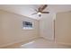 Cozy bedroom features a ceiling fan, neutral walls, and a bright window at 233 45Th Ave, St Pete Beach, FL 33706
