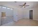 Bedroom with tile floor, closet, and ceiling fan adjacent to spacious living area at 233 45Th Ave, St Pete Beach, FL 33706