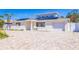 Charming single-story home featuring solar panels, a paved driveway, and well-maintained landscaping at 233 45Th Ave, St Pete Beach, FL 33706