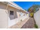 Side view of the home featuring a brick paved walkway and private entrance at 233 45Th Ave, St Pete Beach, FL 33706