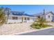 Charming single-story home featuring solar panels, a paved driveway, and well-maintained landscaping at 233 45Th Ave, St Pete Beach, FL 33706
