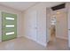 Inviting foyer with a unique green door and neutral tile flooring at 233 45Th Ave, St Pete Beach, FL 33706