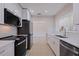 Modern kitchen with stainless steel appliances and white cabinets at 233 45Th Ave, St Pete Beach, FL 33706