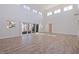 Spacious living room with soaring ceilings, large windows, and sliding glass doors to the outside at 233 45Th Ave, St Pete Beach, FL 33706