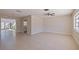 Open-concept living room featuring tile floors, neutral paint, ceiling fan, and natural light at 233 45Th Ave, St Pete Beach, FL 33706