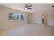 Bright living room featuring tile floors, a ceiling fan, and a stylish green door at 233 45Th Ave, St Pete Beach, FL 33706