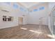 Bright open space featuring wood-look tile flooring and views to the kitchen and backyard at 233 45Th Ave, St Pete Beach, FL 33706