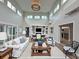 Bright, airy living room featuring high ceilings, clerestory windows and white sofas in a neutral color palette at 233 45Th Ave, St Pete Beach, FL 33706