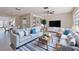 Relaxing living room with ceiling fan, television and comfortable seating and a blue striped rug at 233 45Th Ave, St Pete Beach, FL 33706