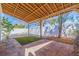 Inviting covered outdoor patio with paver flooring, wooden beams, privacy fence, and artificial grass at 233 45Th Ave, St Pete Beach, FL 33706