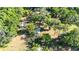 A captivating aerial view of a wooded property featuring a charming home nestled among mature trees at 27477 Old Trilby Rd, Brooksville, FL 34602