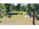 Spacious backyard featuring picnic tables and mature trees, creating an ideal space for outdoor gatherings and relaxation at 27477 Old Trilby Rd, Brooksville, FL 34602