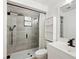 Modern bathroom with glass-enclosed shower, tile surround, rainfall showerhead, and updated vanity at 27477 Old Trilby Rd, Brooksville, FL 34602