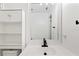Bright bathroom featuring a sink with black faucet, storage cabinet, and large mirror at 27477 Old Trilby Rd, Brooksville, FL 34602