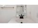 Bright bathroom featuring a sink with black faucet, a shower, and towel rack at 27477 Old Trilby Rd, Brooksville, FL 34602