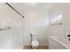 Well-lit bathroom featuring a glass shower, toilet, and white sink with black faucet at 27477 Old Trilby Rd, Brooksville, FL 34602