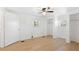 Well-lit bedroom with wood floors, ceiling fan, and closet space at 27477 Old Trilby Rd, Brooksville, FL 34602