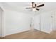 Light-filled bedroom with hardwood floors and access to an en suite at 27477 Old Trilby Rd, Brooksville, FL 34602