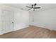 Bright bedroom with wood floors, ceiling fan, and two doors at 27477 Old Trilby Rd, Brooksville, FL 34602