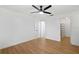 Bedroom featuring a ceiling fan, wood-look flooring, and access to a closet at 27477 Old Trilby Rd, Brooksville, FL 34602