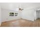 Bright bedroom with hardwood floors, ceiling fan, and natural light from large windows at 27477 Old Trilby Rd, Brooksville, FL 34602