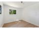 Light and airy bedroom with wood floors and a large window at 27477 Old Trilby Rd, Brooksville, FL 34602