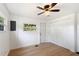 Bedroom featuring wood floors, windows, closet, and access to the exterior at 27477 Old Trilby Rd, Brooksville, FL 34602