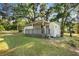 Charming single-story home featuring a lattice-covered front porch and a spacious, tree-filled yard at 27477 Old Trilby Rd, Brooksville, FL 34602