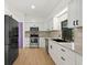 Stylish kitchen featuring modern appliances, white cabinets, and granite countertops at 27477 Old Trilby Rd, Brooksville, FL 34602