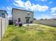 Spacious backyard with a patio, furniture, and a privacy fence at 2870 Silver Scallop Dr, Wimauma, FL 33598