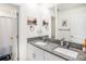 Well-lit bathroom features double sinks, granite countertops, and modern fixtures at 2870 Silver Scallop Dr, Wimauma, FL 33598
