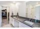 Bright bathroom with double vanity sinks, granite countertops, and walk-in shower at 2870 Silver Scallop Dr, Wimauma, FL 33598