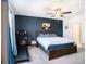A bedroom featuring blue accent wall, a bed with blue pillows, and a treadmill at 2870 Silver Scallop Dr, Wimauma, FL 33598